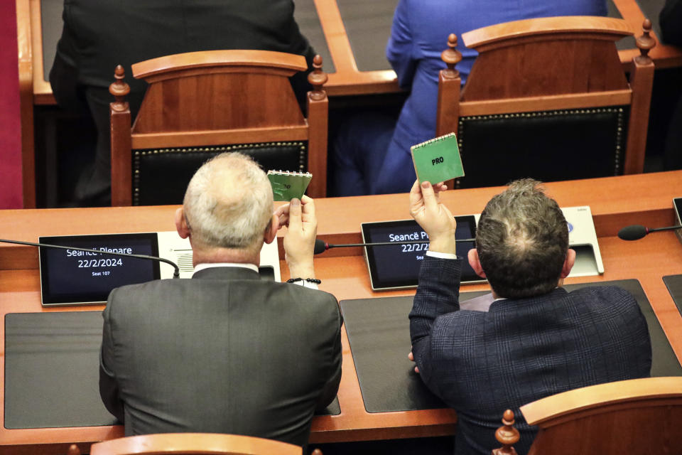 Lawmakers of the ruling Socialist party vote in Tirana, Albania, Thursday, Feb. 22, 2024. Albania’s Parliament on Thursday approved a deal for the country to hold thousands of migrants rescued in international waters by Italy while their asylum applications are processed, despite protests from opposition lawmakers and human rights groups. (AP Photo/Armando Babani)