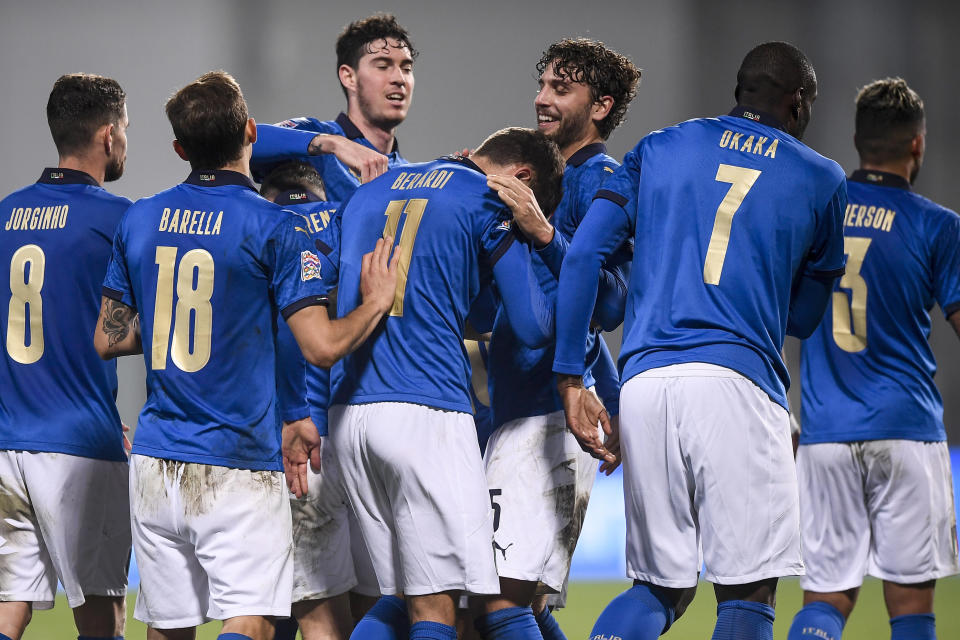 Italy's players celebrate after their teammate Domenico Berardi, center (11) scored the winning goal during the UEFA Nations League soccer match between Italy and Poland at Mapei Stadium, in Reggio Emilia, Italy, Sunday, Nov. 15, 2020. (Fabio Ferrari/LaPresse via AP)