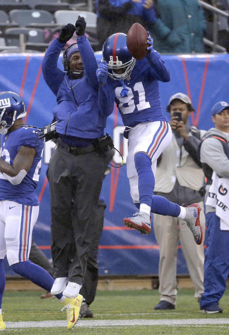 New York Giants wide receiver Russell Shepard (81) celebrates with wide receivers coach Tyke Tolbert after catching a touchdown pass from wide receiver Odell Beckham during the second half of an NFL football game against the Chicago Bears, Sunday, Dec. 2, 2018, in East Rutherford, N.J. (AP Photo/Seth Wenig)