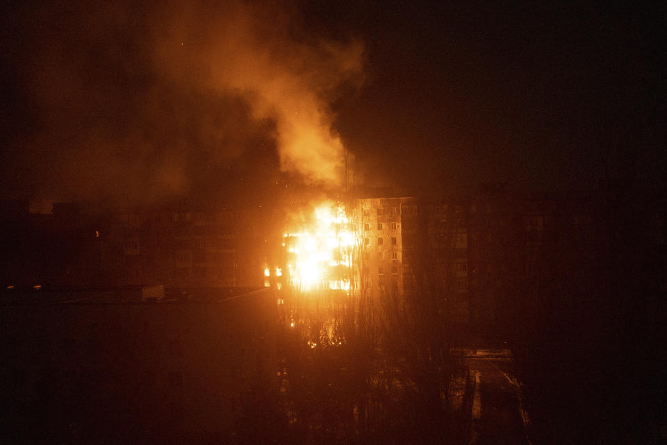 FILE - A fire burns at an apartment building after it was hit by the shelling of a residential district in Mariupol, Ukraine, Friday, March 11, 2022. (AP Photo/Mstyslav Chernov, File)