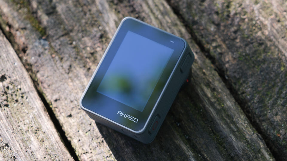 Akaso Brave 8 Lite action camera screen on a wooden surface outside