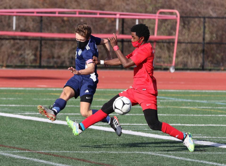 Tolman's Darius Davis, right, controls the ball away from a South Kingstown player during a match in 2021.