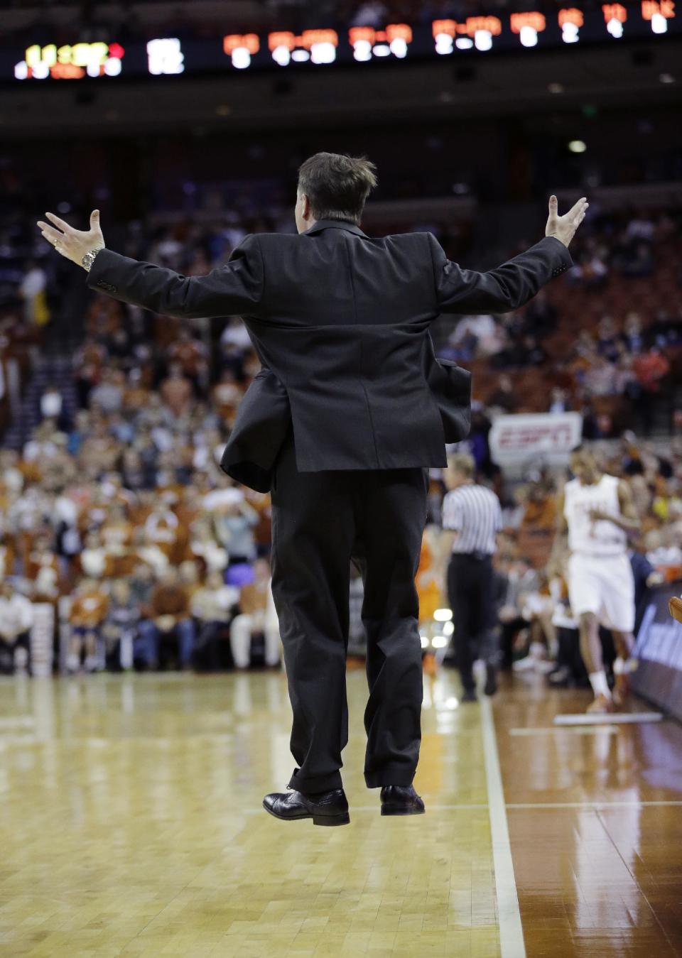 Oklahoma State coach Travis Ford jumps as he yells to his players during the first half on an NCAA college basketball game against Texas, Tuesday, Feb. 11, 2014, in Austin, Texas. (AP Photo/Eric Gay)