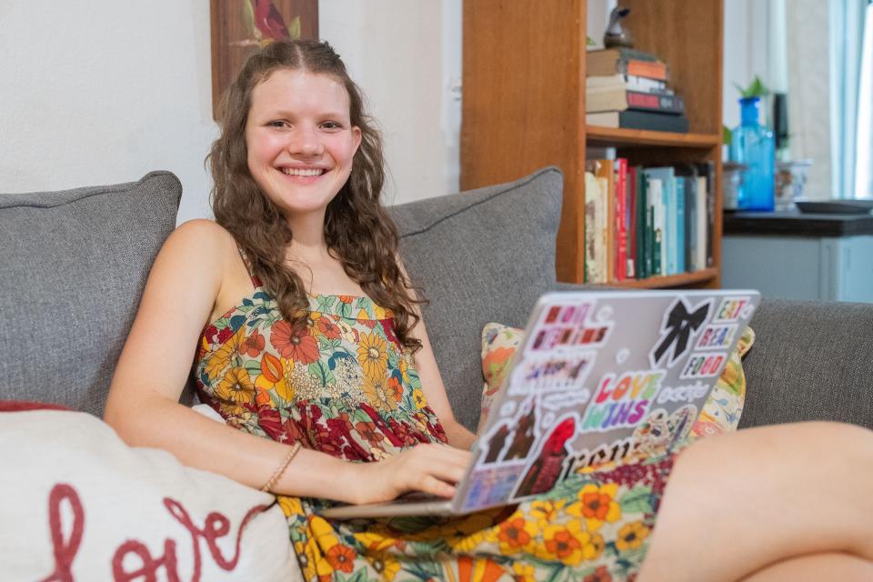 Emma Cate Duggar sits on the couch where she does her schoolwork. Duggar was accepted to Mount Holyoke, which is the first women's college in the country founded in 1837.