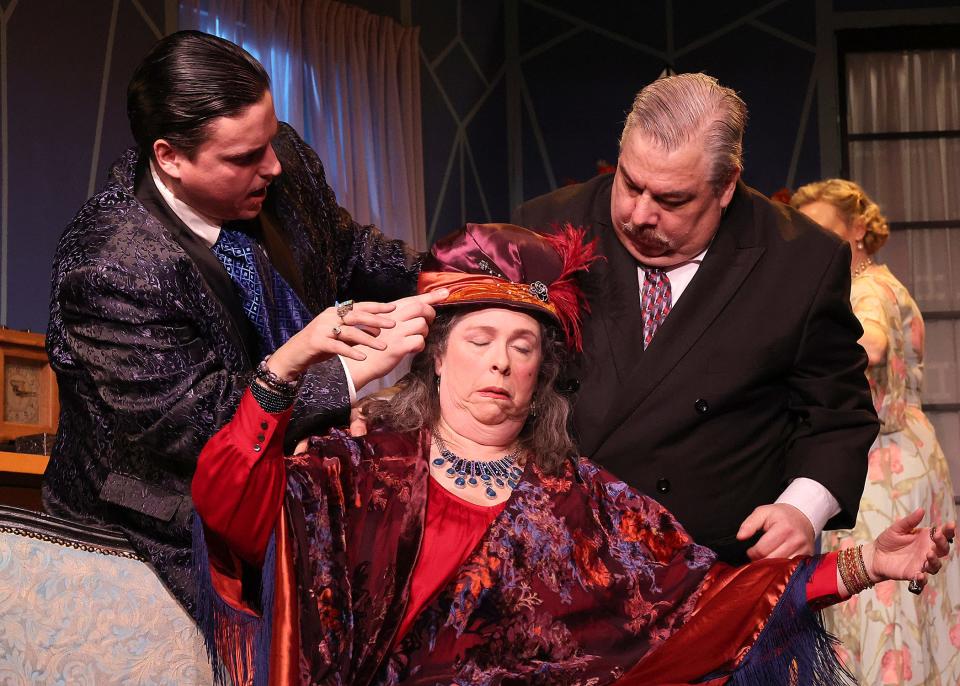 Spiritualist Madame Arcati (Kathleen Larson Day) is flanked by Charles (Zack Johnson) on the left and Dr. Bradman (Alex Lucchesi) as she swoons in Noel Coward's "Blithe Spirit," playing through Feb. 11 at Eventide Theatre Company in Dennis.