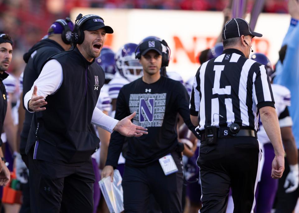 Northwestern interim head coach David Braun, left, protests a personal foul called on his team against Nebraska during the second half of an NCAA college football game Saturday, Oct. 21, 2023, in Lincoln, Neb. (AP Photo/Rebecca S. Gratz)