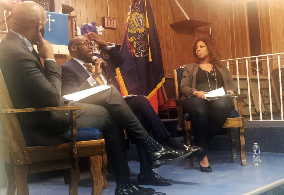 In this Jan. 16, 2020, photo, from left, Harrison Floyd and Paris Dennard of President Donald Trump's reelection campaign black voter outreach effort and Kamilah Prince, the Republican National Committee's director of African American engagement participate in a "Black Voices for Trump" event at Philadelphia's First Immanuel Baptist Church. Trump's reelection campaign is reaching out to black voters through one of their communities' most important institutions — black churches. (AP Photo/Elana Schor)