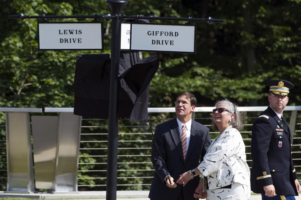 Secretary of the Army Mark Esper, left, and Karen Condon, former executive director, Army National Military Cemeteries, unveil the street signs for tow new streets at Arlington National Cemetery in Arlington, Va., Thursday, Sept. 6, 2018. The streets are named for Marine Corps Gunnery Sgt. Jonathan Gifford and Ida Lewis, U.S. Lighthouse Service. The new streets are part of the cemetery's Millennium expansion protect which will add over 27,000 spaces. (AP Photo/Cliff Owen)