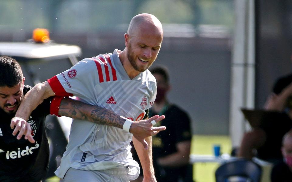 Jul 13, 2020; Orlando, FL, USA; D.C. United midfielder Junior Moreno (5) and Toronto FC midfielder Michael Bradley (4) go for the ball during the first half at the ESPN Wide World of Sports. Mandatory Credit: Peter Casey-USA TODAY Sports