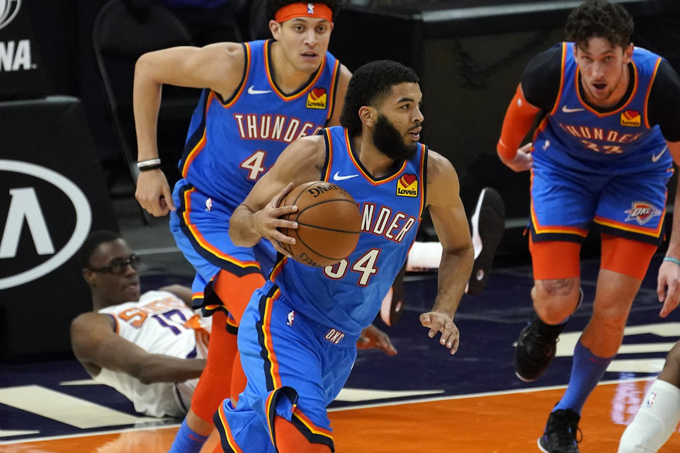 Oklahoma City Thunder guard Kenrich Williams (34) pushes the ball up court against the Phoenix Suns during the first half of an NBA basketball game, Wednesday, Jan. 27, 2021, in Phoenix. (AP Photo/Matt York)