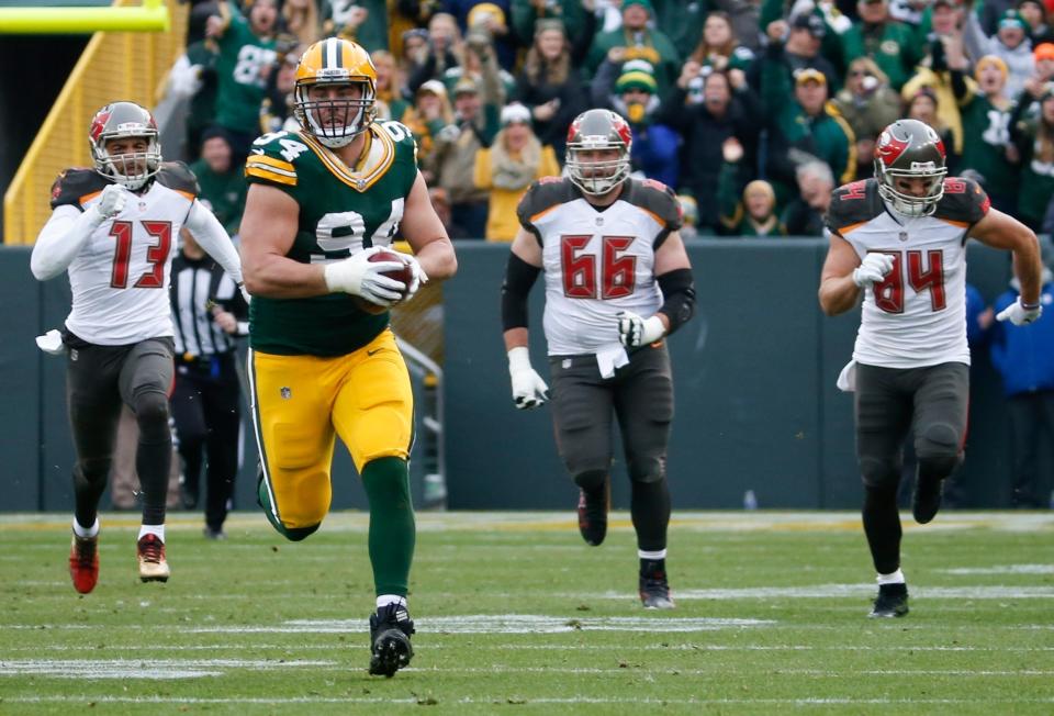 Green Bay Packers' Dean Lowry runs back a fumble recovery for a touchdown during the first half of an NFL football game against the Tampa Bay Buccaneers Sunday, Dec. 3, 2017, in Green Bay, Wis. (AP Photo/Mike Roemer)