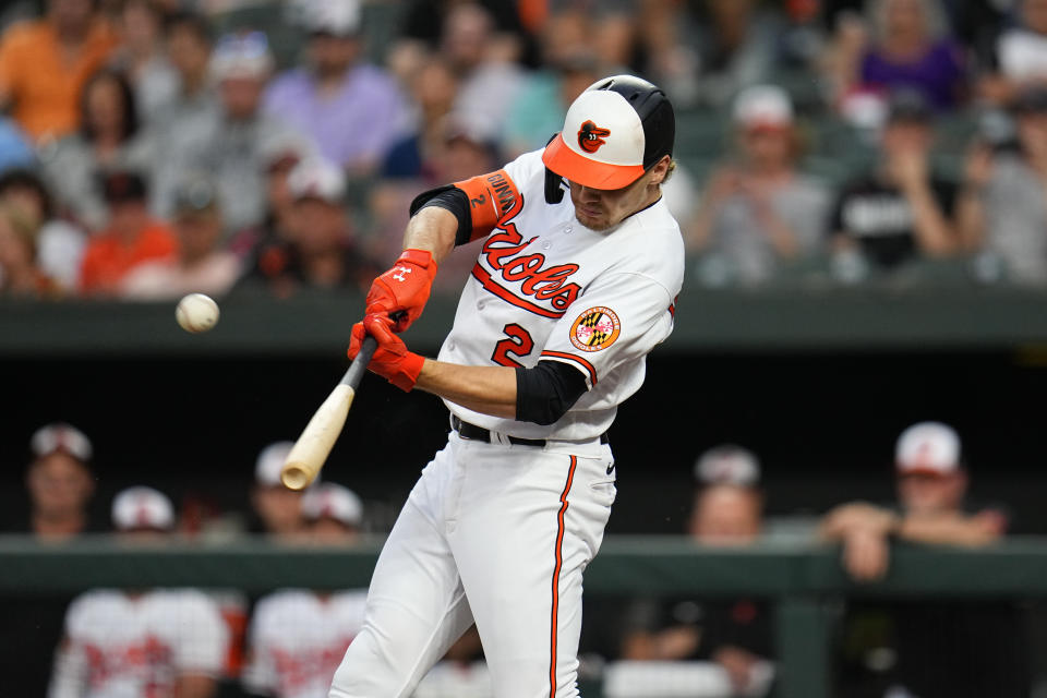 Baltimore Orioles' Gunnar Henderson connects for a grand slam home run off Toronto Blue Jays starting pitcher Chris Bassitt during the third inning of a baseball game, Tuesday, June 13, 2023, in Baltimore. Orioles' Aaron Hicks, Ramon Urias and Jorge Mateo scored on the home run. (AP Photo/Julio Cortez)