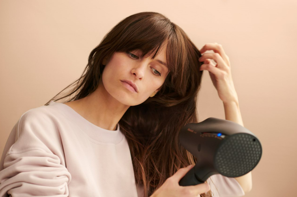 Woman using a Panasonic hair dryer