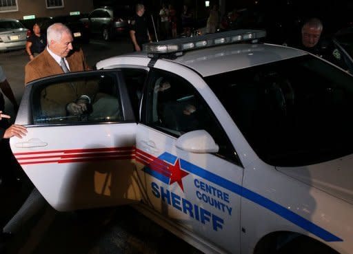 Former Penn State assistant football coach Jerry Sandusky is led into a police car in handcuffs after being convicted in his child sex abuse trial at the Centre County Courthouse in Pennsylvania on June 22. Sandusky stood accused of molesting 10 boys over a 15-year period