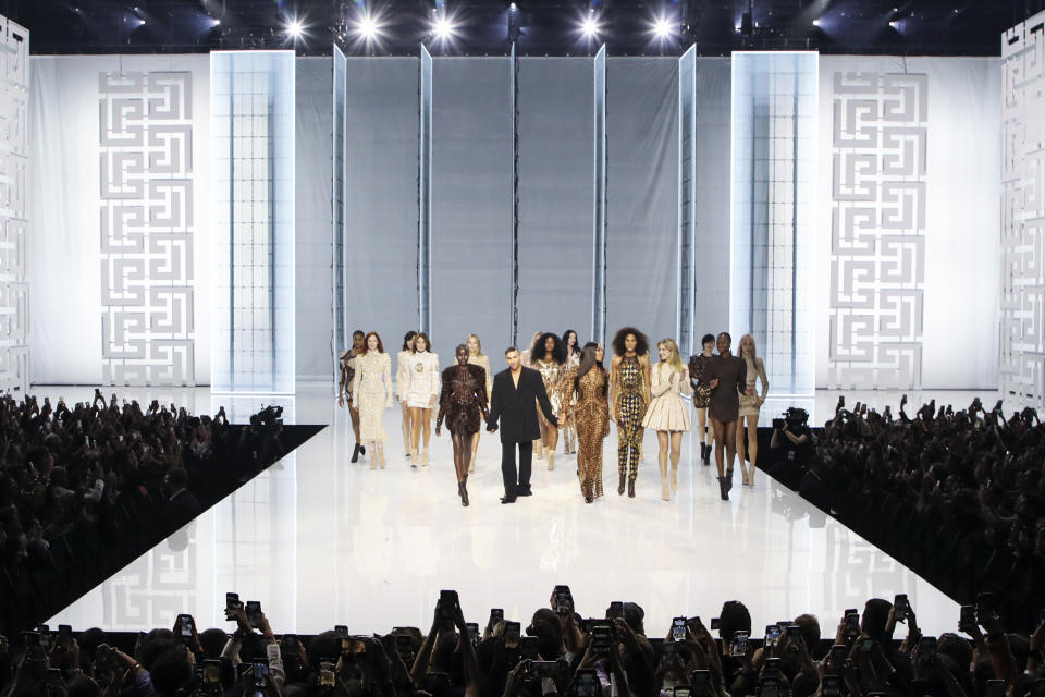 Olivier Rousteing, center, accepts applause as he walks with models at the conclusion of the Balmain Spring-Summer 2022 ready-to-wear fashion show in Paris, Wednesday, Sept. 29, 2021. (Photo by Vianney Le Caer/Invision/AP)