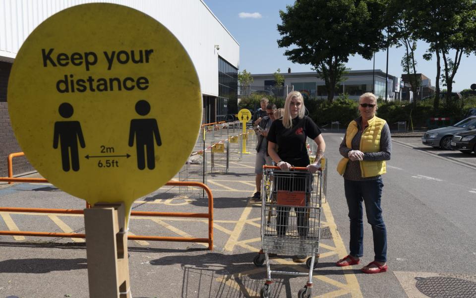 A sign reminds customers at a DIY store in London about observing the two-metre rule - Ming Yeung/Getty Images Europe