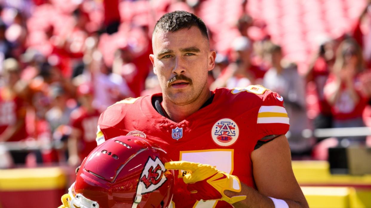 Kansas City Chiefs tight end Travis Kelce points to the Chiefs decal on his helmet.