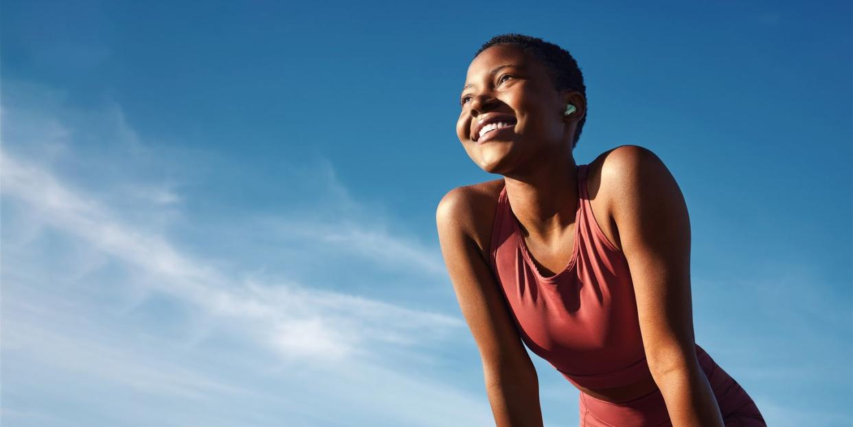 femme person smiling wearing workout clothes