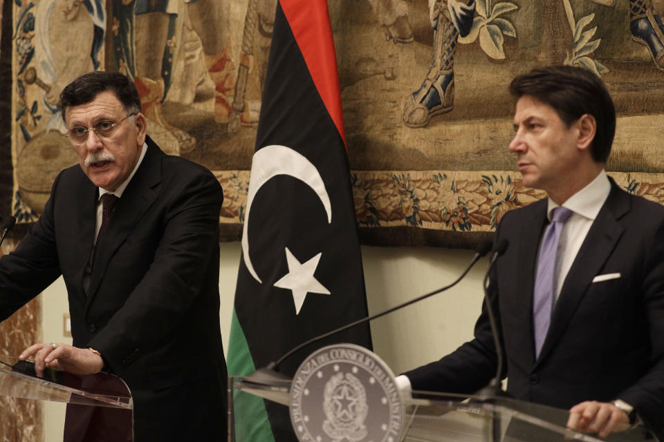 Libya's Prime Minister Fayez al-Sarraj, left, holds a joint press conference with Italian Premier Giuseppe Conte after their meeting at Chigi palace, in Rome, Saturday, Jan. 11, 2020. (AP Photo/Gregorio Borgia)