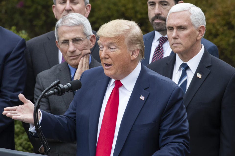 President Donald Trump, accompanied by Dr. Anthony Fauci, director of the National Institute of Allergy and Infectious Diseases, left, and Vice President Mike Pence, right, speaks during a news conference about the coronavirus in the Rose Garden at the White House, Friday, March 13, 2020, in Washington. (AP Photo/Alex Brandon)