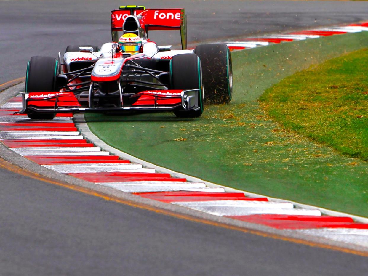 McLaren Formula One driver Lewis Hamilton of Britain drives over the rumble strips during qualifying at the Australian F1 Grand Prix in Melbourne March 27, 2010.