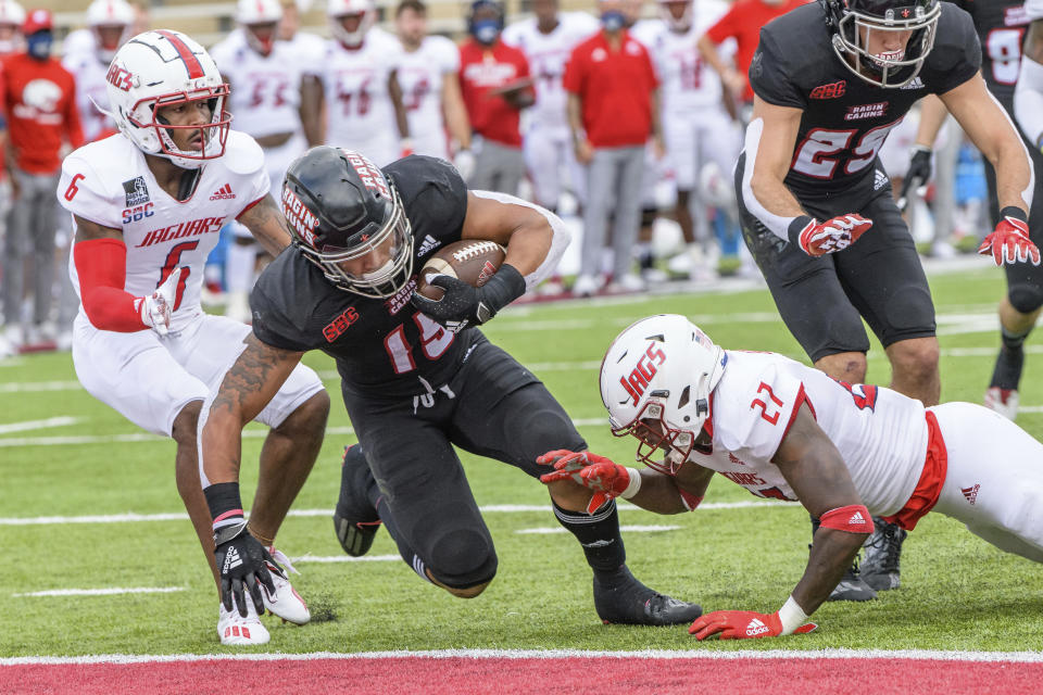 Louisiana-Lafayette running back Elijah Mitchell (15) scores a touchdown against South Alabama safety Dewayne Betts Jr. (27) in the first half an NCAA college football game in Lafayette, La., Saturday, Nov. 14, 2020. (AP Photo/Matthew Hinton)