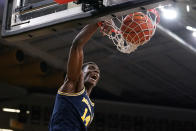 Michigan forward Moussa Diabate dunks the ball during the first half of an NCAA college basketball game against Iowa, Thursday, Feb. 17, 2022, in Iowa City, Iowa. (AP Photo/Charlie Neibergall)