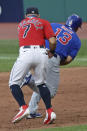 Chicago Cubs' David Bote (13) is tagged out by Cleveland Indians' Cesar Hernandez (7) in the fifth inning in a baseball game, Wednesday, Aug. 12, 2020, in Cleveland. (AP Photo/Tony Dejak)