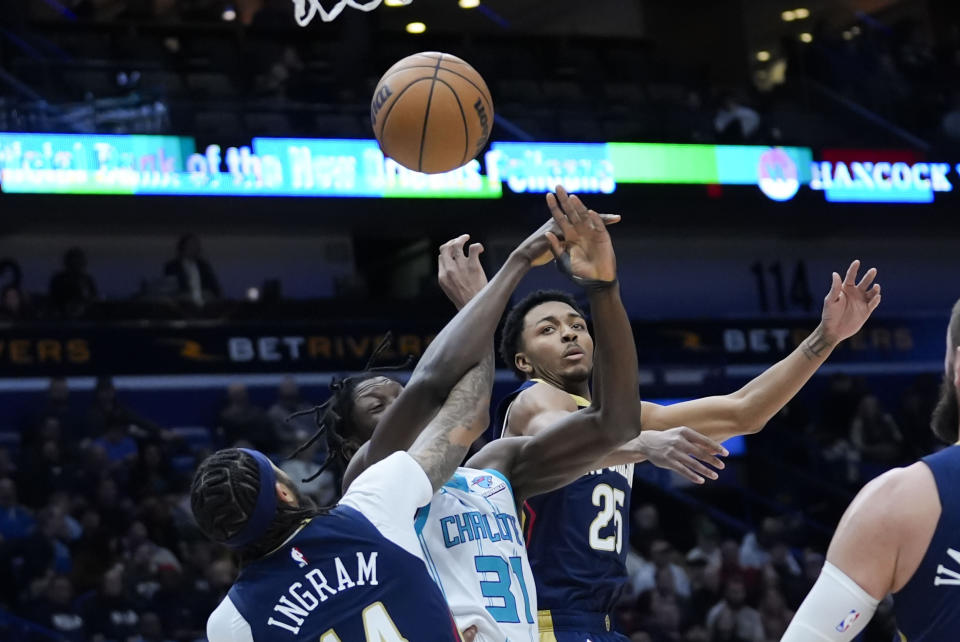 Charlotte Hornets center Nathan Mensah (31) battles under the basket with New Orleans Pelicans forward Brandon Ingram (14) and guard Trey Murphy III (25) in the first half of an NBA basketball game in New Orleans, Wednesday, Jan. 17, 2024. (AP Photo/Gerald Herbert)