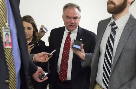 Senator Tim Kaine (D-VA) speaks to reporters as he walks to the Senate Chamber to vote on legislation for funding the Department of Homeland Security on Capitol Hill in Washington March 2, 2015. REUTERS/Joshua Roberts