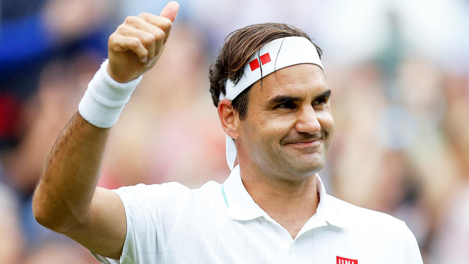 Roger Federer gives a thumbs up to fans.