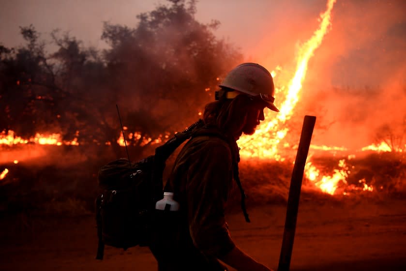 YUCAIPA, CALIFORNIA SEPTEMBER 7, 2020-A firefighter helps to set bck fires as the El dorado Fire approaches in Tucaipa Monday. (Wally Skalij/Los Angeles Times)