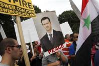 Syrian Americans rally in support of Syrian President Bashar al-Assad and against proposed U.S. military action against Syria, in a park at the U.S. Capitol in Washington, September 9, 2013. REUTERS/Jonathan Ernst