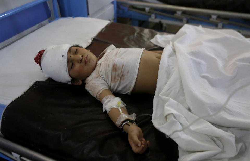 A child, who was injured in bus and train accident, lies on bed after receiving initial treatment at a hospital in Sheikhupura near Lahore, Pakistan, Friday, July 3, 2020. A passenger train crashed into a bus carrying Sikh pilgrims at an unmanned railway crossing in eastern Pakistan, police and rescue officials said. (AP Photo/K.M. Chaudary)