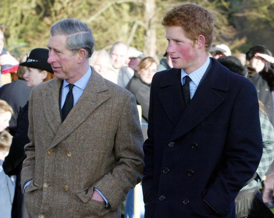 King Charles III with young Prince Harry at St Mary Magdalene Church on Sandringham estate, in 2004 (AFP via Getty Images)