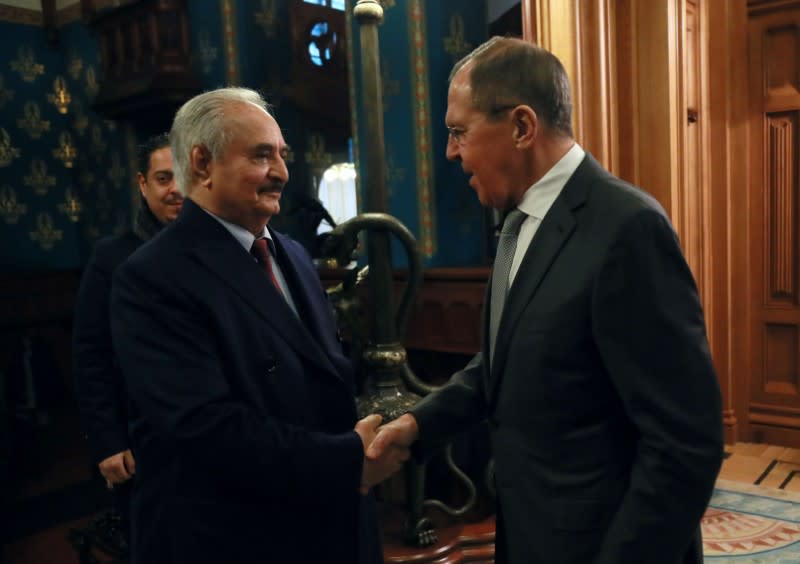 Commander of the Libyan National Army Khalifa Haftar shakes hands with Russian Foreign Minister Sergei Lavrov before talks in Moscow