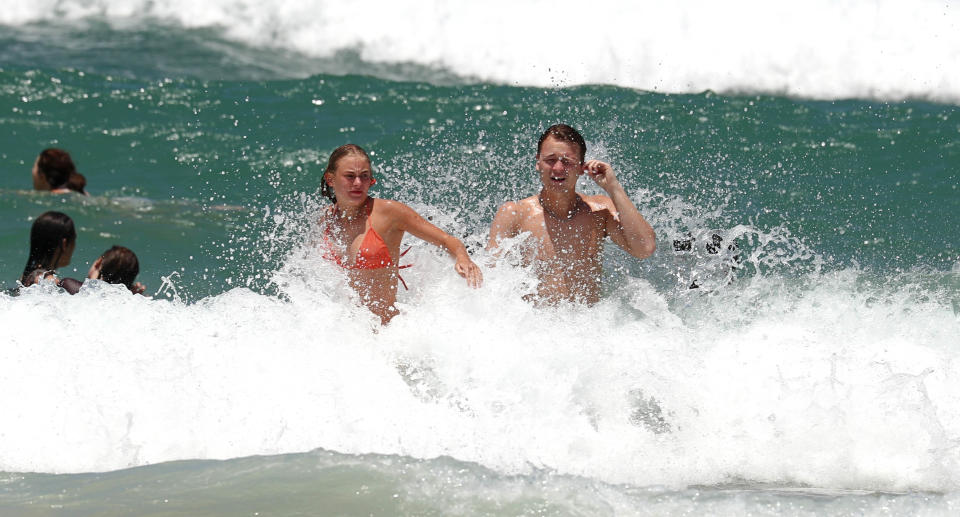 People in waves at the beach.