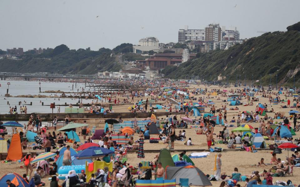 People enjoy the hot weather at Boscombe beach in Dorset - Andrew Matthews /PA