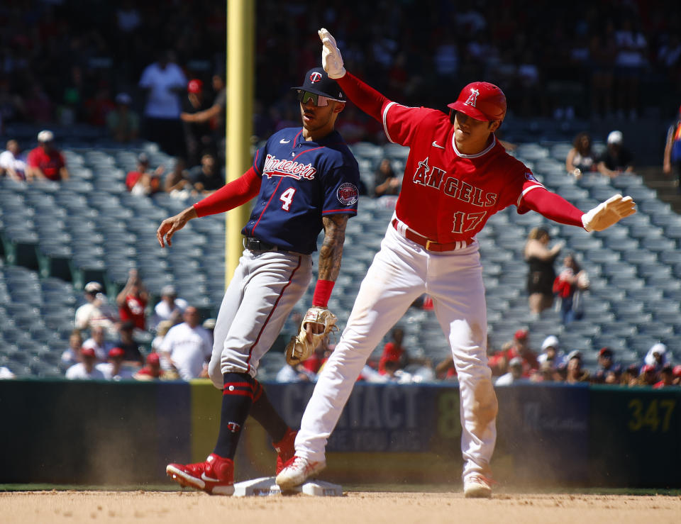 ANAHEIM, CALIFORNIA - AUGUST 14:  Shohei Ohtani #17 of the Los Angeles Angels after thrown out at second against Carlos Correa #4 of the Minnesota Twins in the fifth inning at Angel Stadium of Anaheim on August 14, 2022 in Anaheim, California. (Photo by Ronald Martinez/Getty Images)