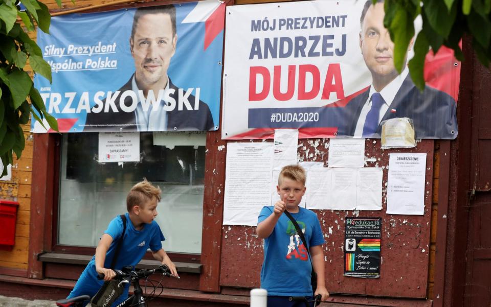 Photo election campaign posters of incumbent conservative president, Andrzej Duda, right, and his challenger, the liberal Warsaw mayor Rafal Trzaskowski - AP