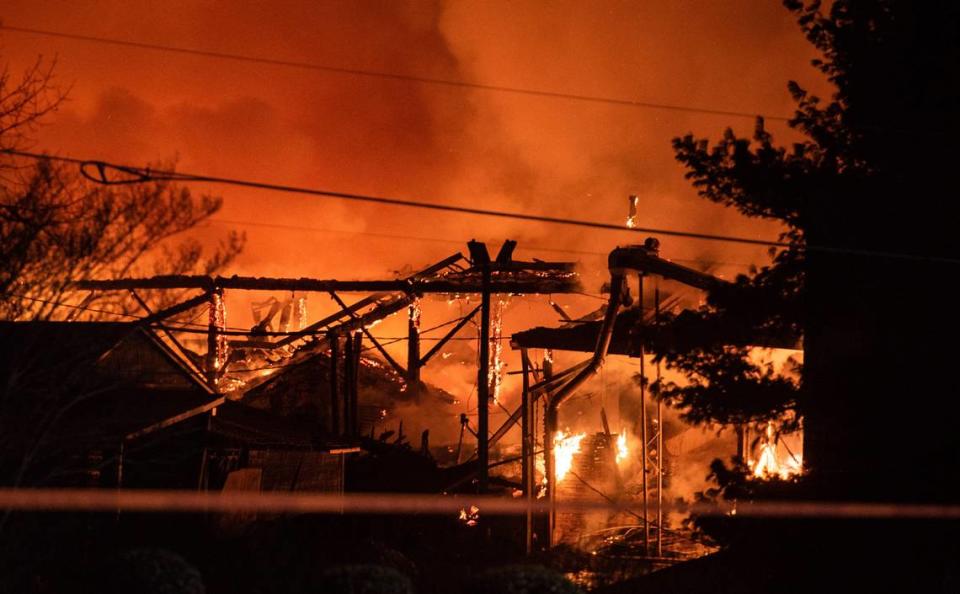 A structure fire burns at the Weaver Fertilizer Plant on Monday, Jan. 31, 2022, in Winston-Salem, N.C. (Allison Lee Isley/The Winston-Salem Journal via AP)