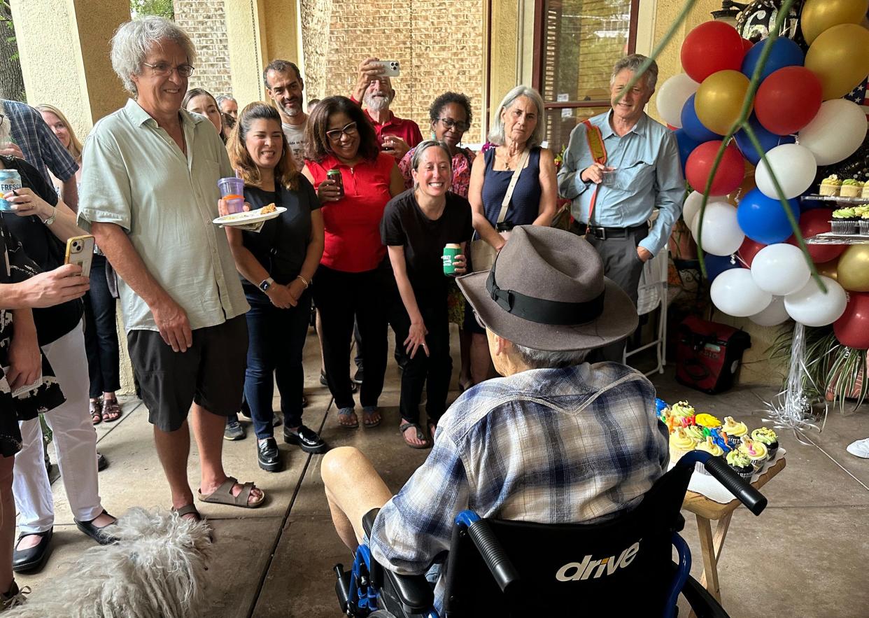 Former Austin City Council member Chris Riley, seated, visits with family and friends, including, from left, Ken Riley, Perla Cavazos, Nikelle Meade and Leah Bojo, during Riley's 60th birthday party at his home on July 12.