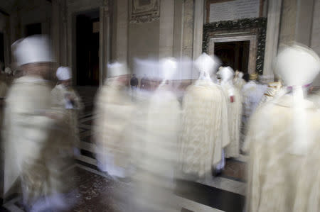 Cardinals walk in procession after Pope Francis opened the Holy Door to mark the opening of the Catholic Holy Year, or Jubilee, in St. Peter's Basilica, at the Vatican, in this December 8, 2015 file photo. REUTERS/Max Rossi/Files