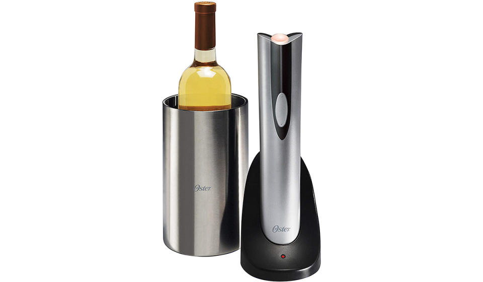 Bottle of white wine in stainless steel chiller and Oster branded electric bottle opener in charging stand next to it.
