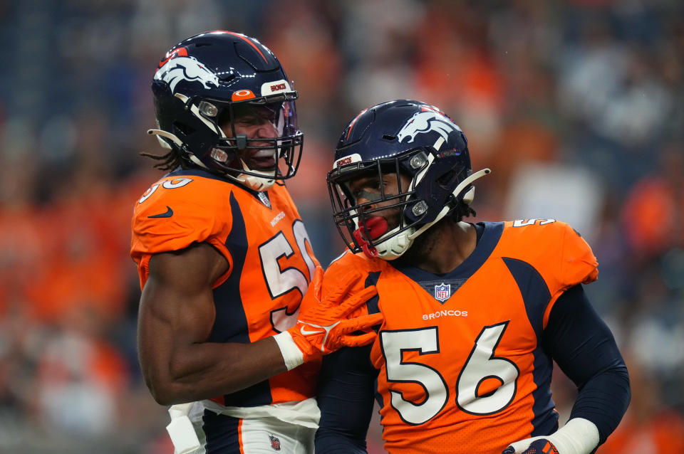 Denver Broncos linebacker Baron Browning (56) and linebacker Jonas Griffith (50) celebrate after a play in the first quarter against the Dallas Cowboys.