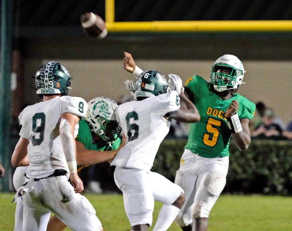 DeLand QB T.J. Moore (5) looks to pass during a game with Flagler Palm Coast at Spec Martin Stadium in DeLand, Friday, Nov. 4, 2022.