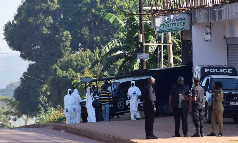 FILE PHOTO: Ugandan police members secure the scene of an explosion in Komamboga, on the northern outskirts of Kampala