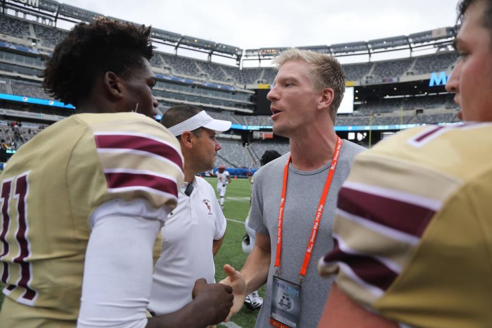 Quarterback, Darius Wilson of Iona Prep and Matt Simms at the end of the game against Pope John as part of the Battle for the Bridge High School Football competition at Metlife Stadium in East Rutherford , NJ on September 14, 2019.