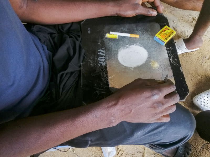 Man shows a substance known as "bombe", a mix of catalytic converters' crushed honeycomb and pills, in Kinshasa