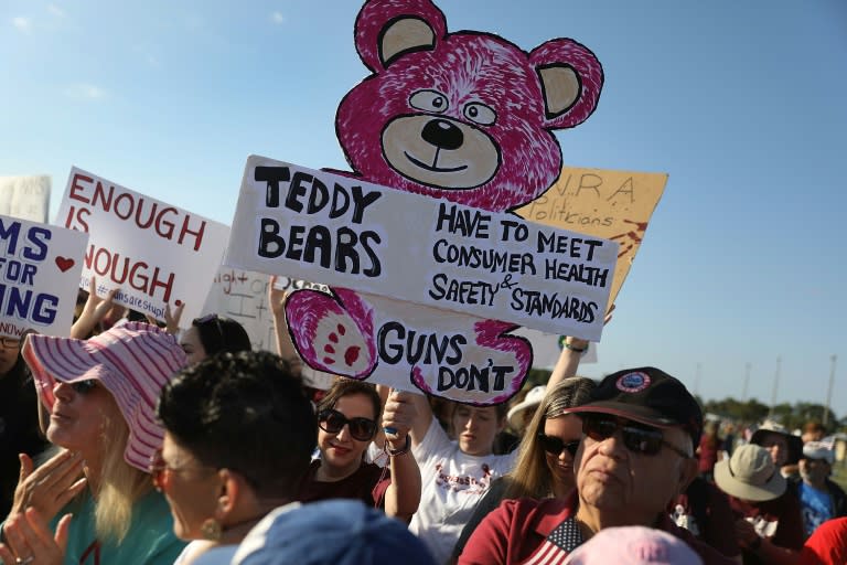 People take part in the March For Our Lives event at Pine Trails Park in Parkland, Florida, where a school shooting left 17 dead in February 2018